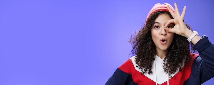 amused girl having fun showing okay zero gesture eye folding lips from amazement as looking 1258 135497